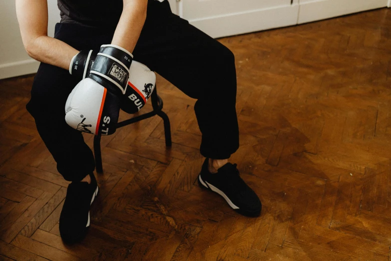 a boy holding a baseball bat and boxing gloves