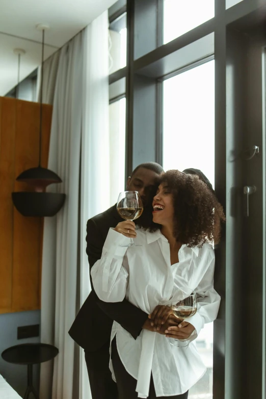 man and woman drinking wine with the sunlight shining through them