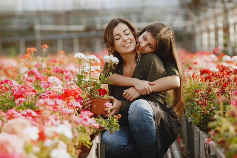 two people sitting together in the flower garden