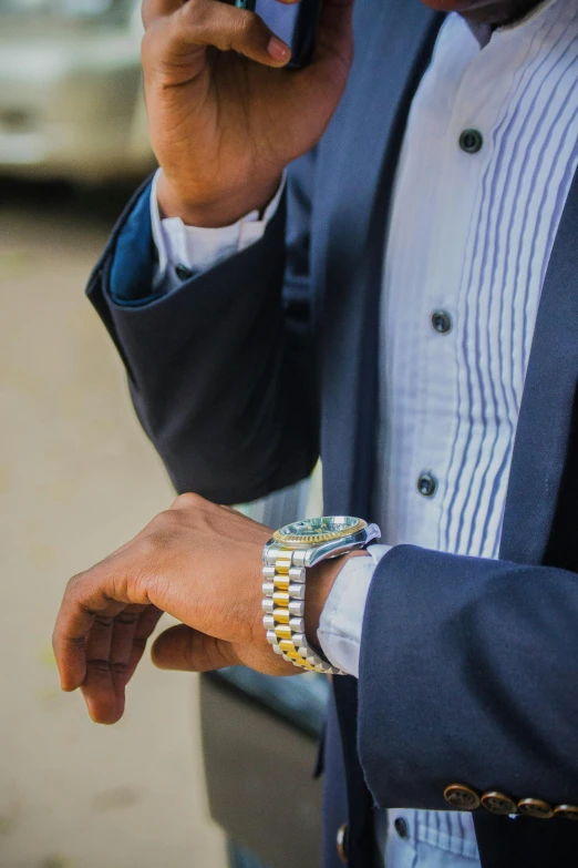 a person in a suit using a cell phone