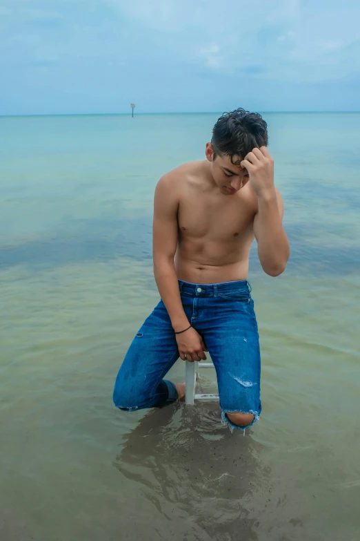 the man is on the beach using his cell phone