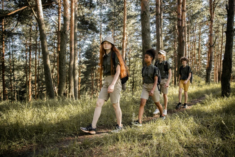 a group of people with backpacks on a path in the woods