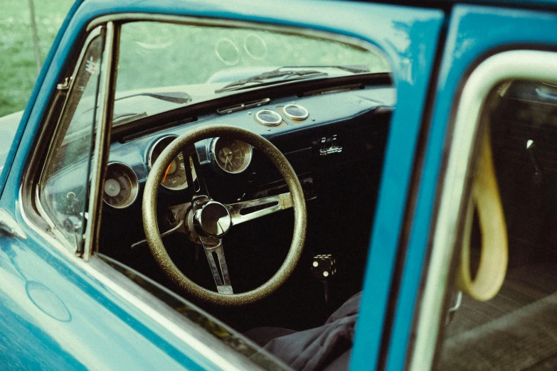 view from inside of old style car and steering wheel