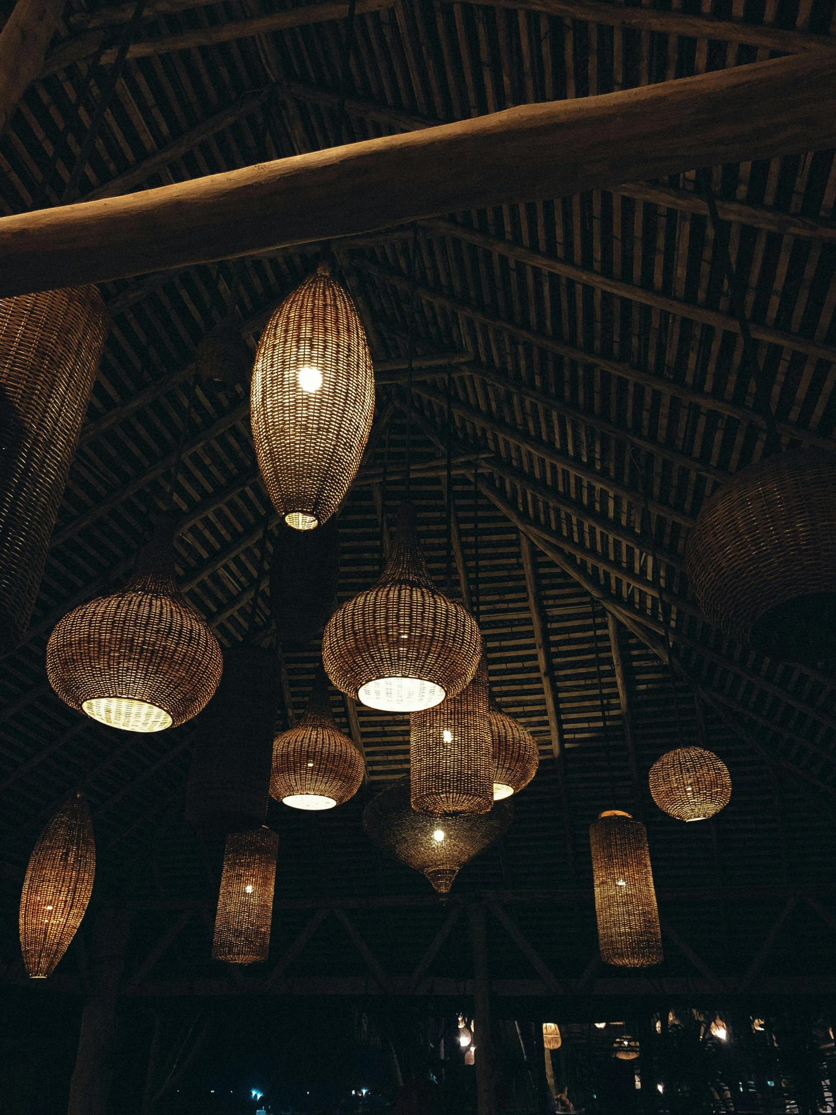 lamps hanging in a ceiling lit with wicker lamps