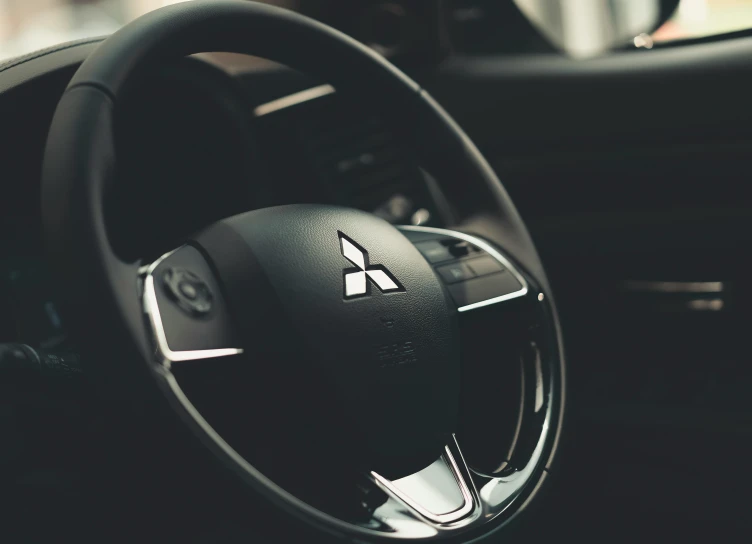 the steering wheel with black leather and white logo