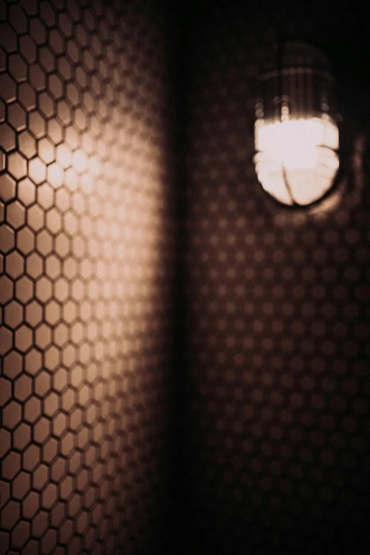 a light in a small room with some hexagonal shapes