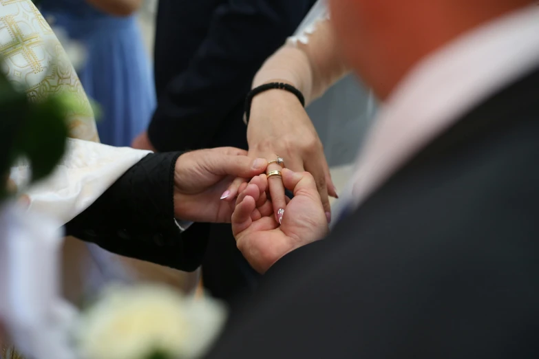 bride and grooms holding hands during a ceremony