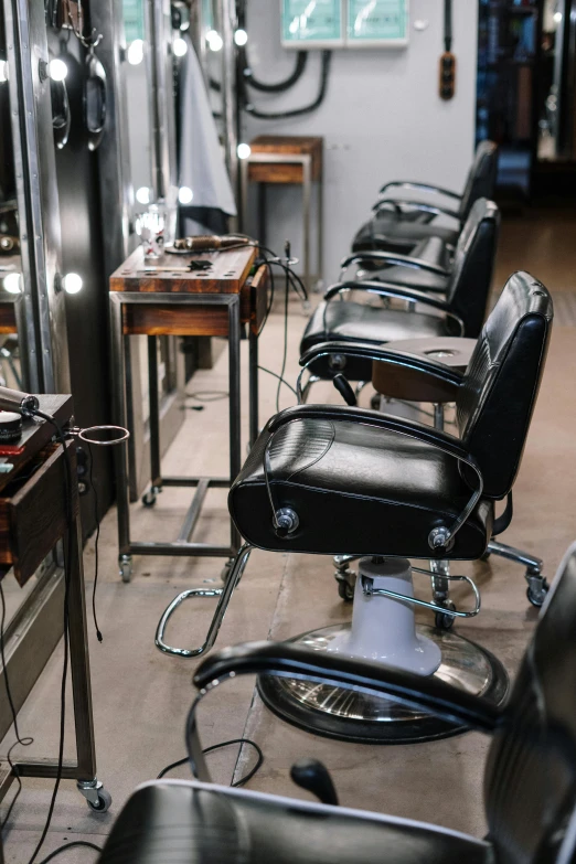 a long row of chairs and mirrors with lighting