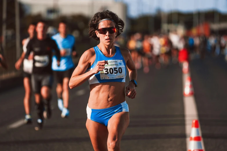 an woman in a bikini running on the road