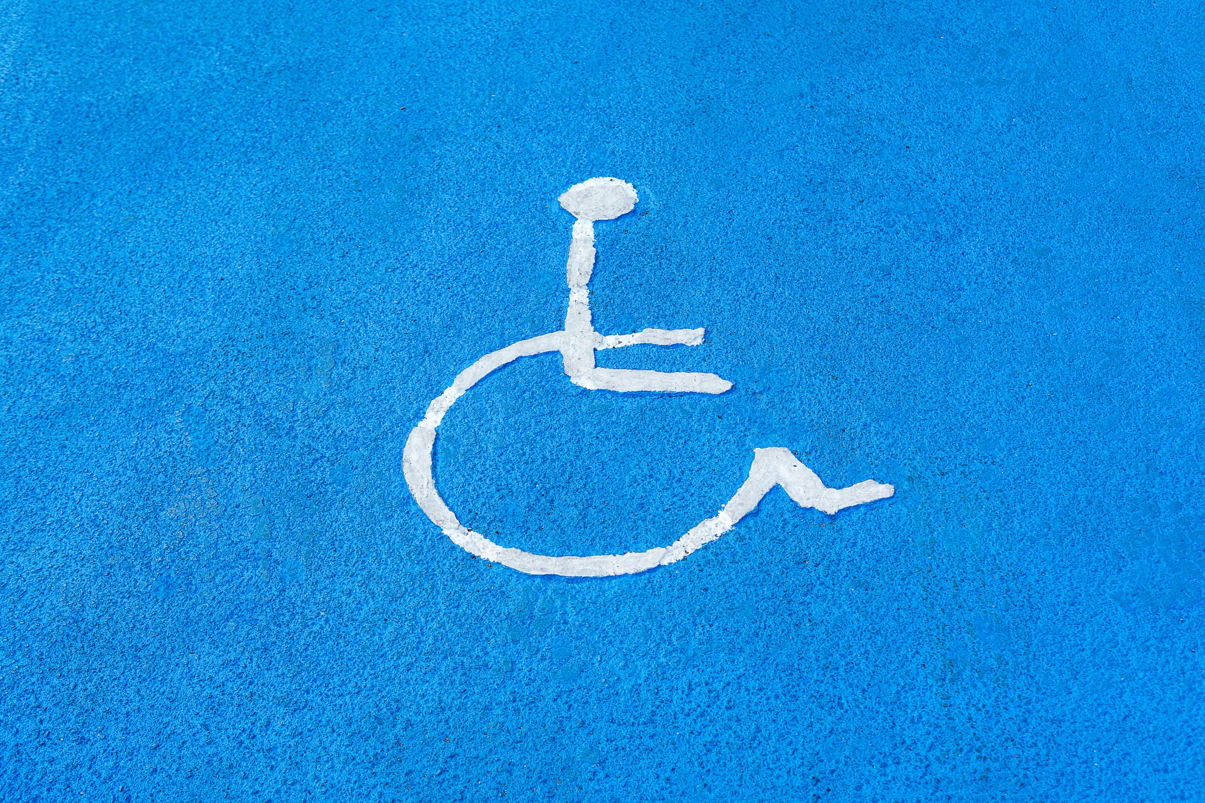 a person with a wheel chair on blue carpet