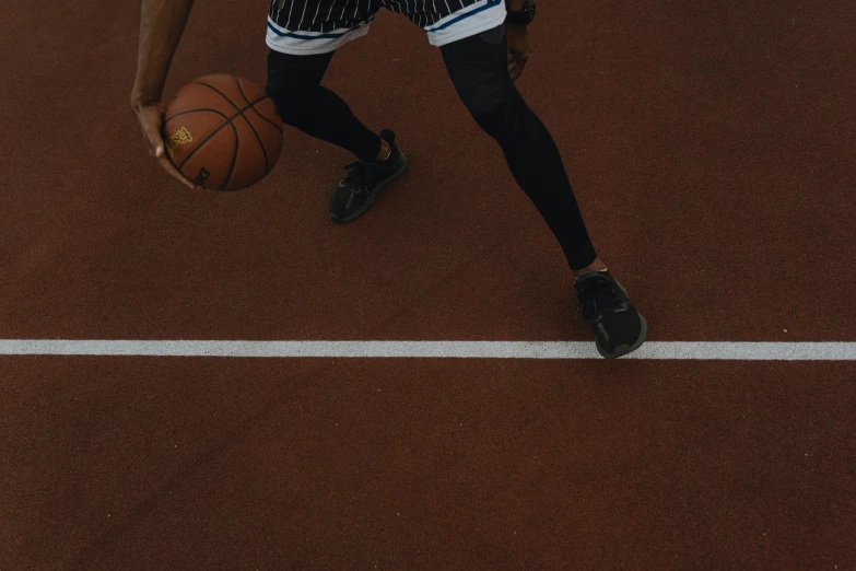 a basketball player is running towards the basket