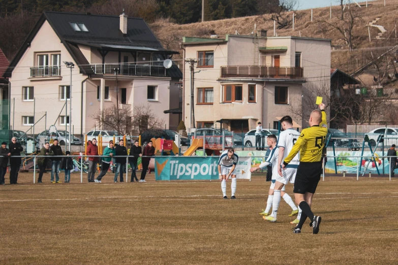 two soccer players high fiving each other in front of a crowd