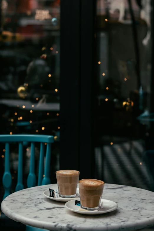 two small cups on an ornate table sit together