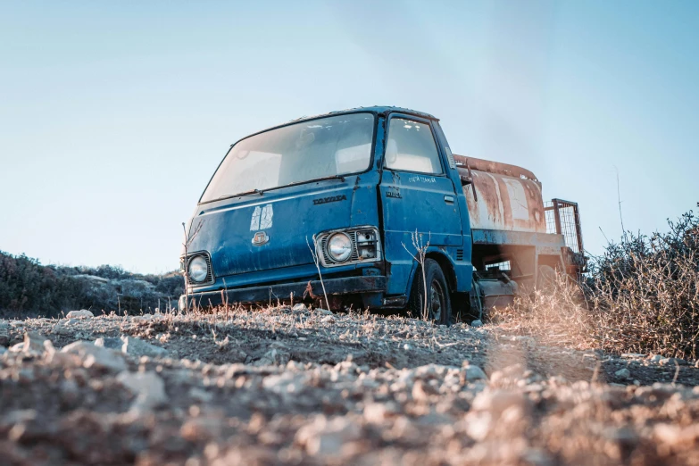 the small van is parked in the grass