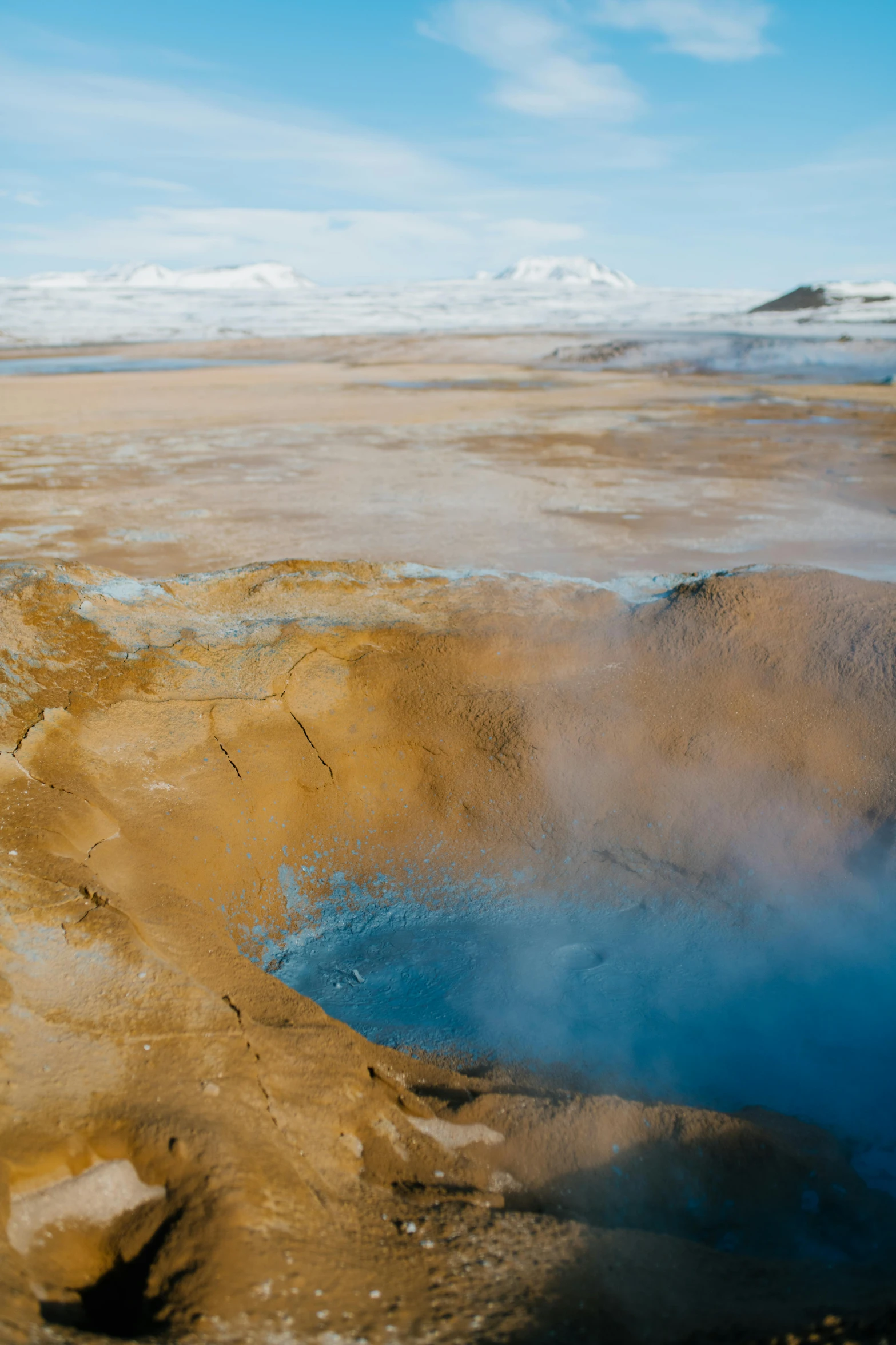 a view of a bright blue pool that has steam rising out of it