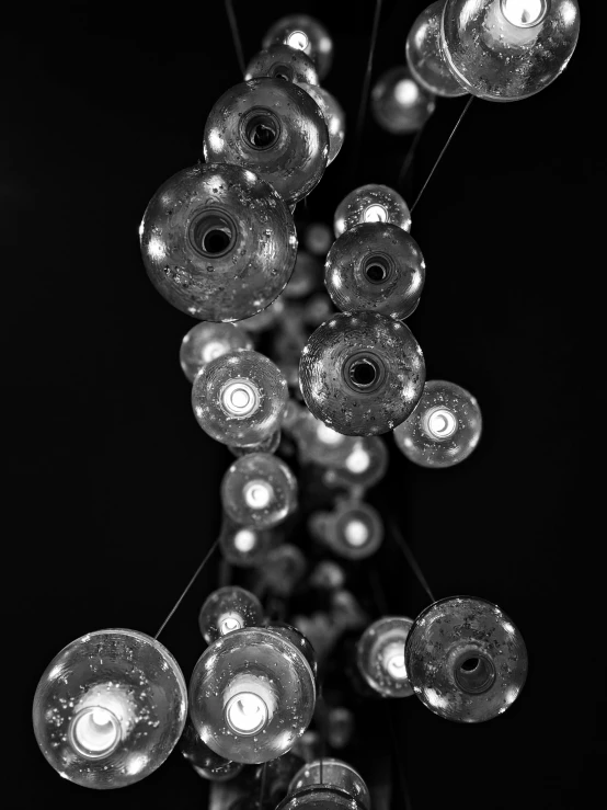 many glass light fixtures in a hanging space