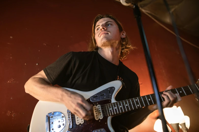 the man is playing the guitar while singing