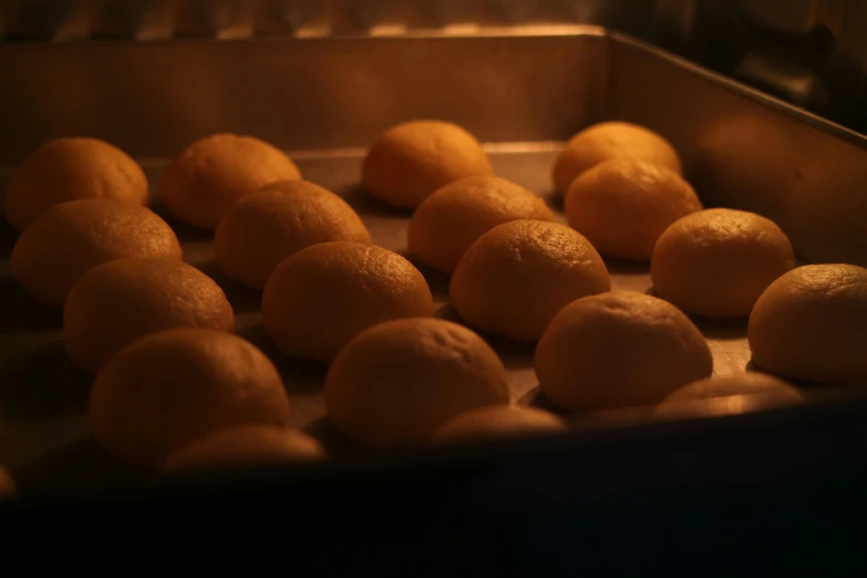 small balls of dough sitting on a table in a pan