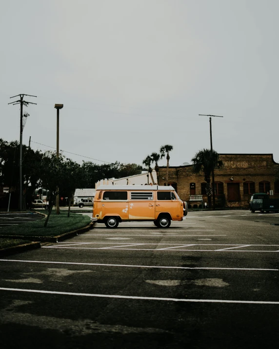 an orange van is parked in a parking lot