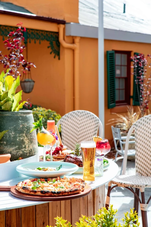 some pizzas and drinks are sitting on the table