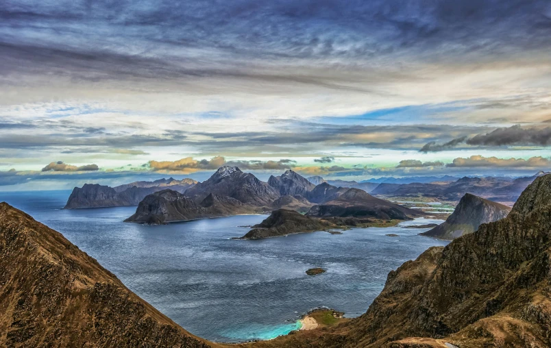 the sea is surrounded by two mountain peaks