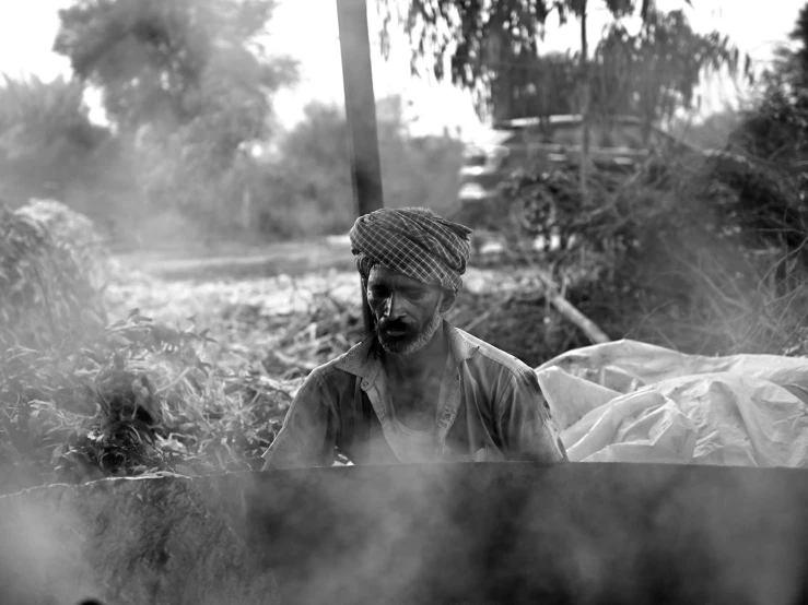 a man with a turban and beard in the woods