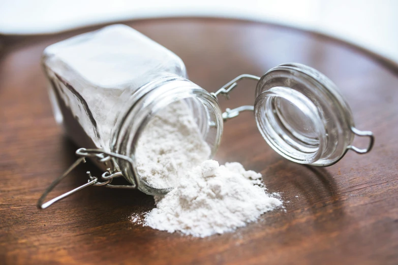 an empty jar that is on a wooden table