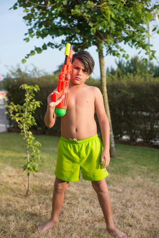 a boy is holding a plastic baseball bat