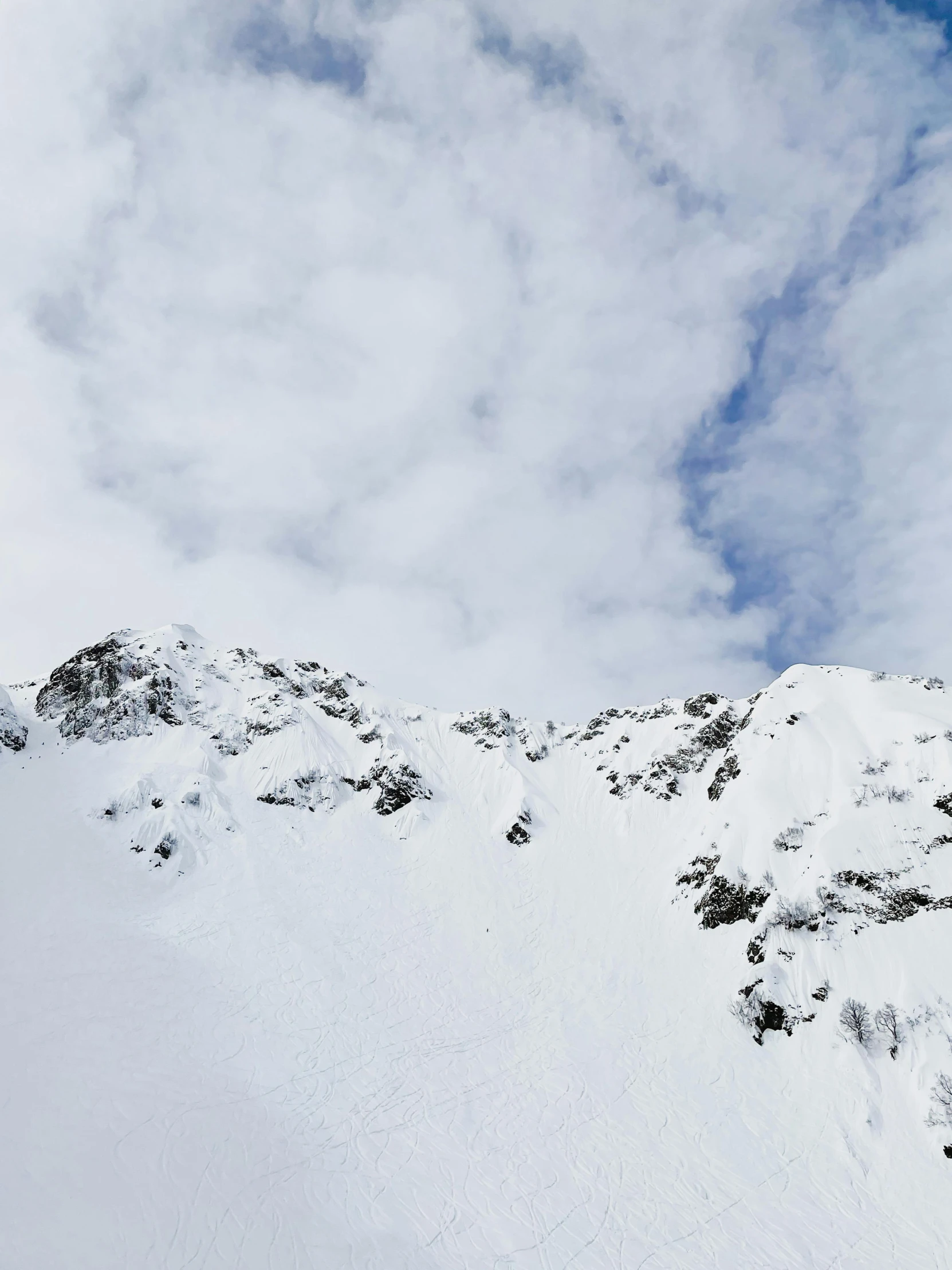 a person riding skis on top of a snow covered slope