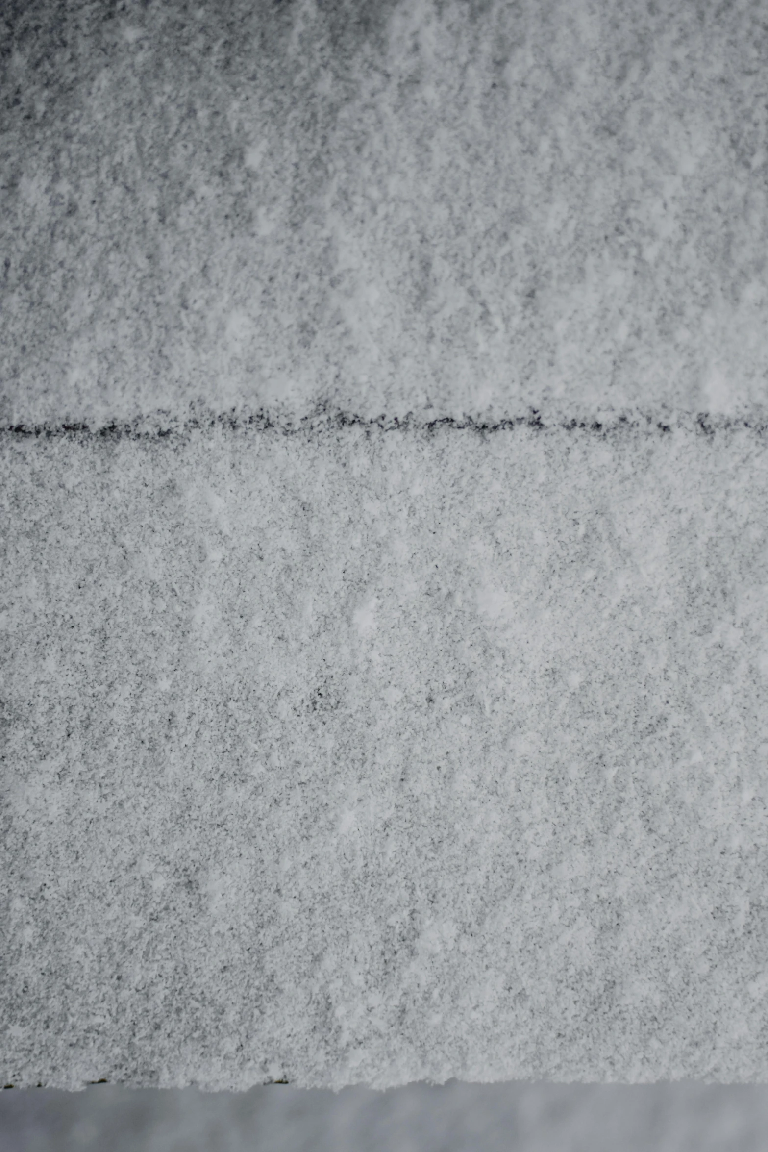 a person standing on snow with a ski board