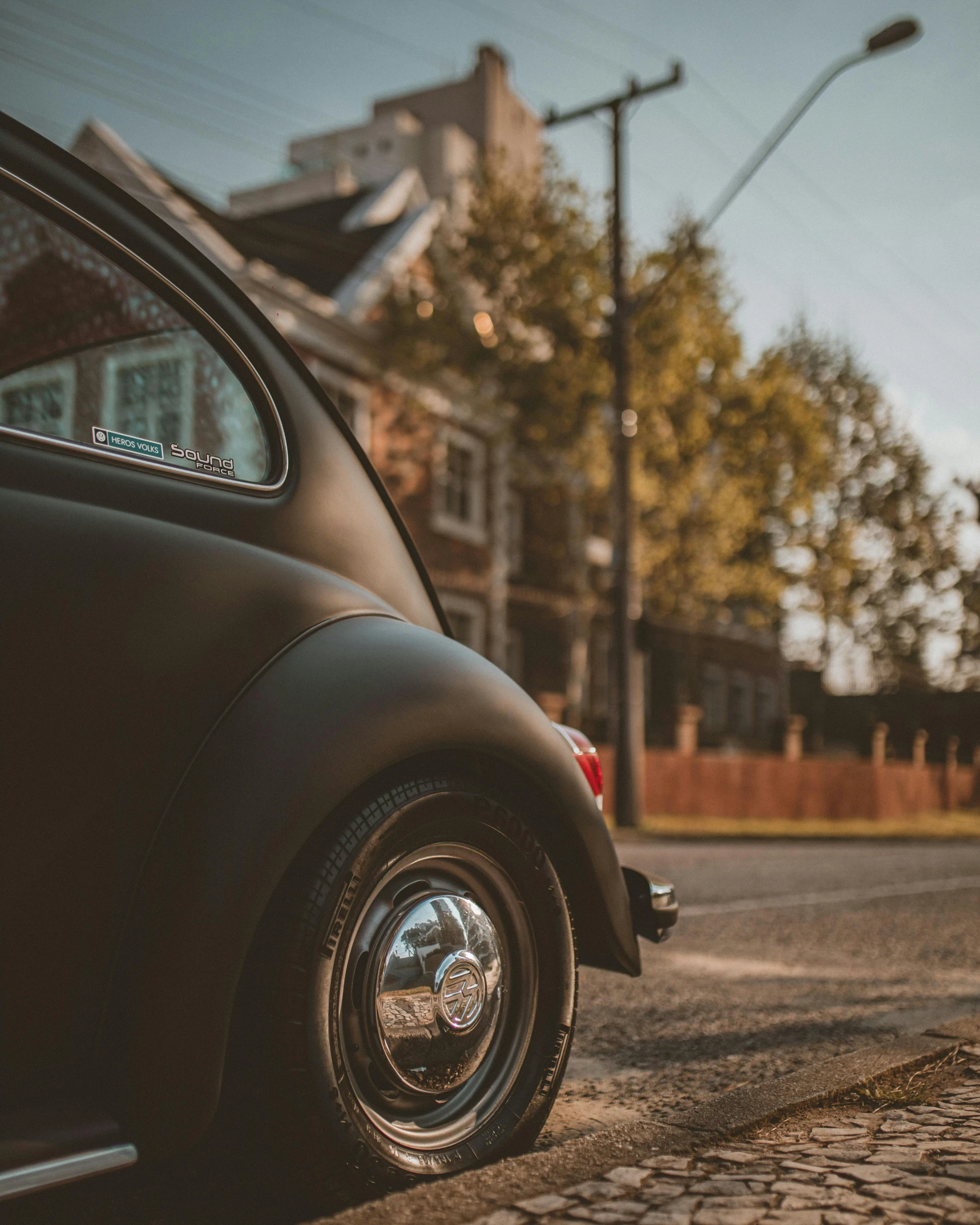 the side of a black car in a street