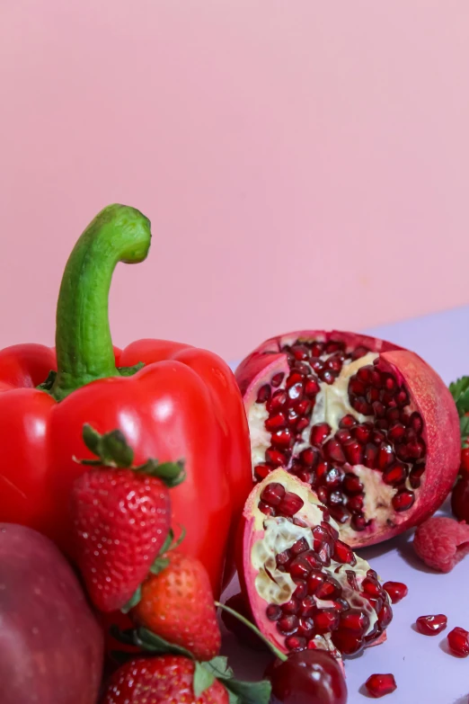 some pomegranates on top of fruits and vegetables