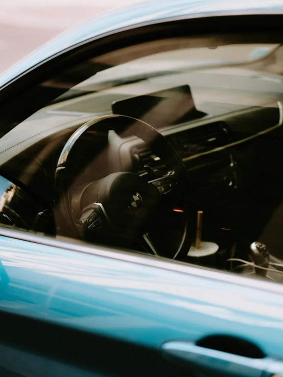 a blue sports car dashboard with a steering wheel