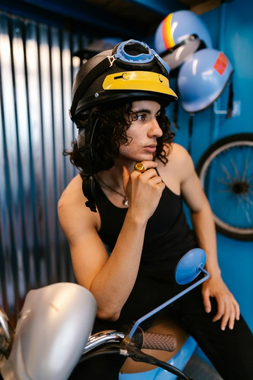 a girl in black riding a motor bike with a helmet