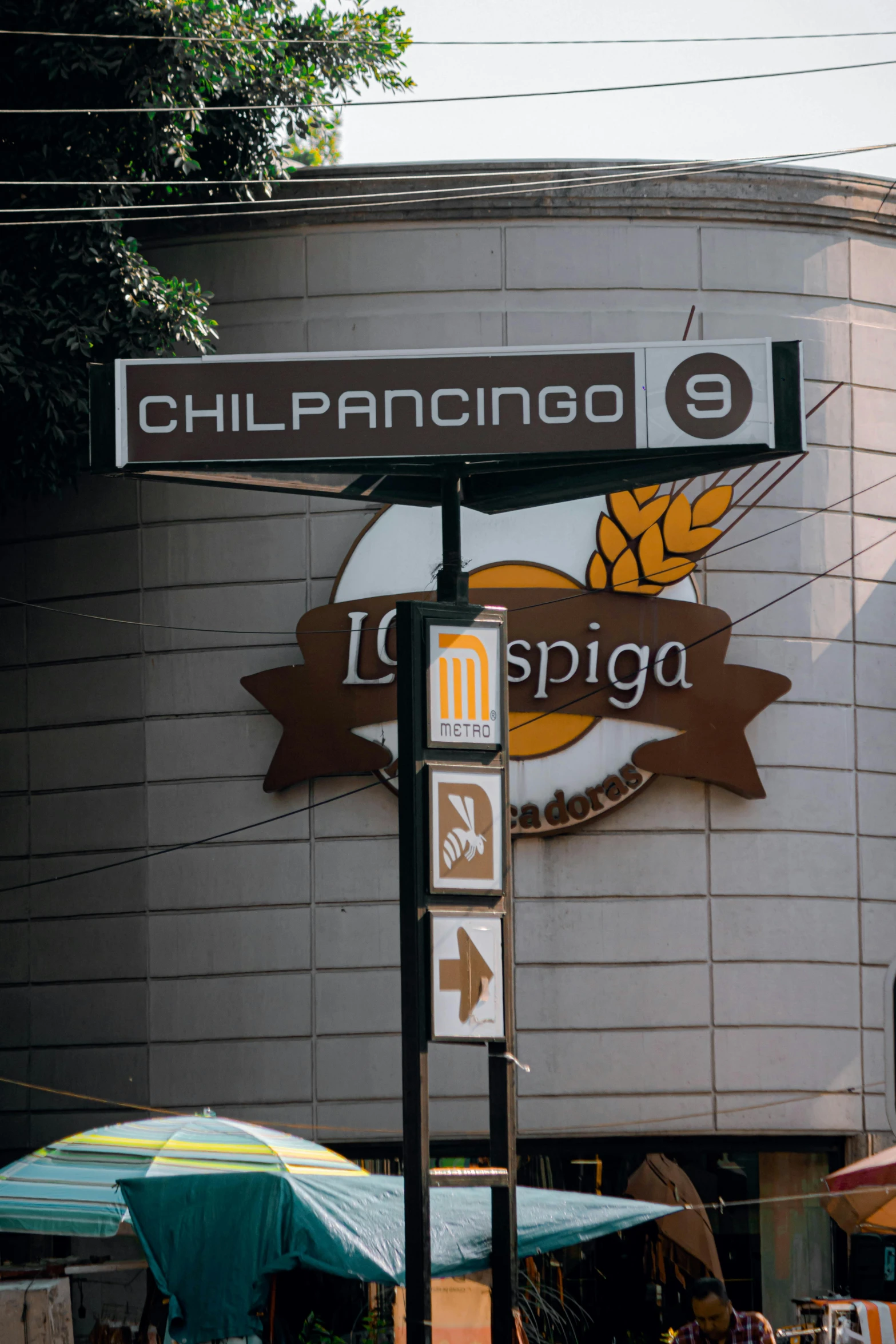 a street sign stands out against a large building