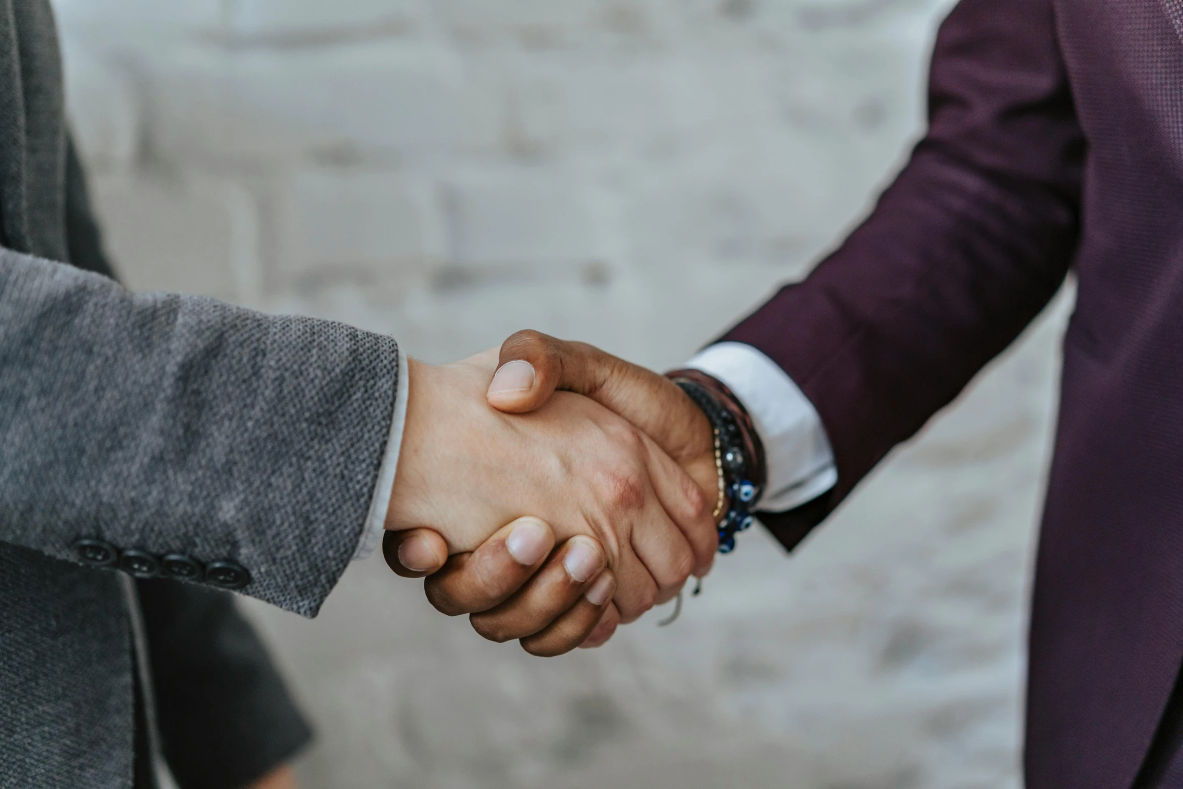 two men in suits are shaking hands