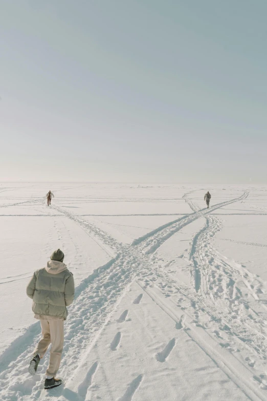 a person walking through snow next to another