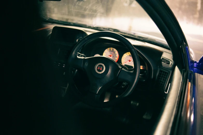 a steering wheel, dashboard and dashboard view from a vehicle