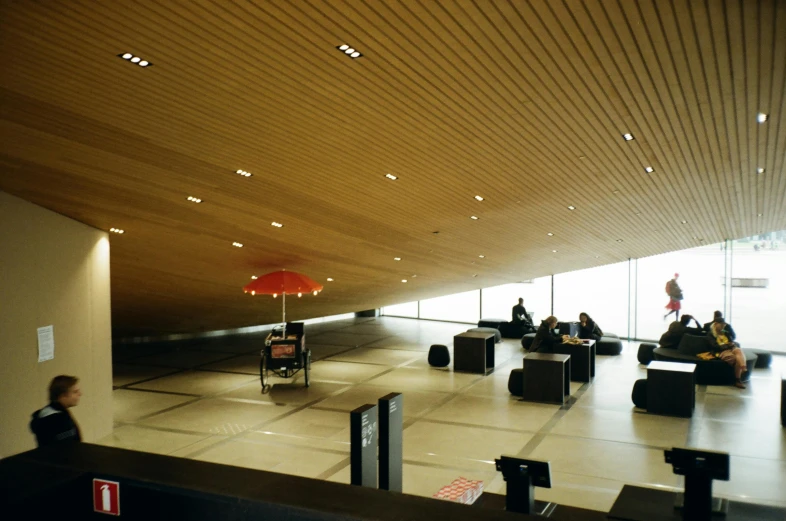 people sitting and standing in an airport lobby