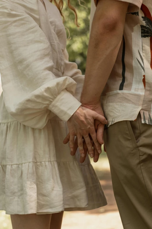two people hold hands in front of each other