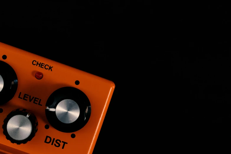 a very small orange pedal over some black background