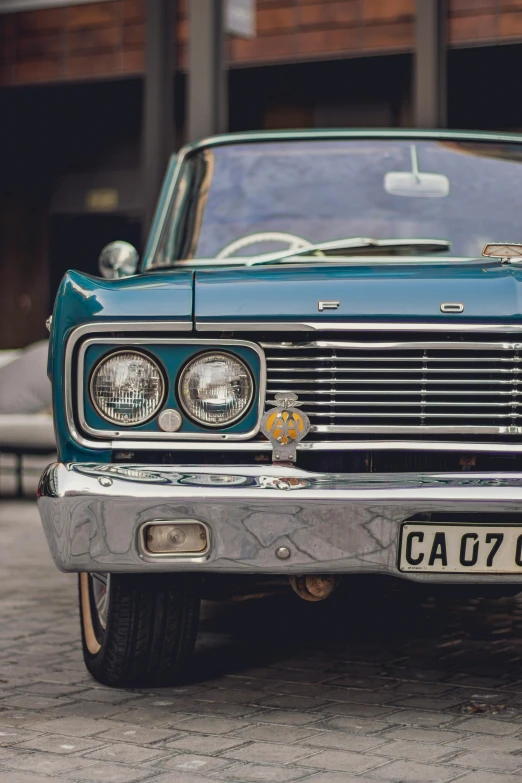 a vintage car with a dog decal on it's grill