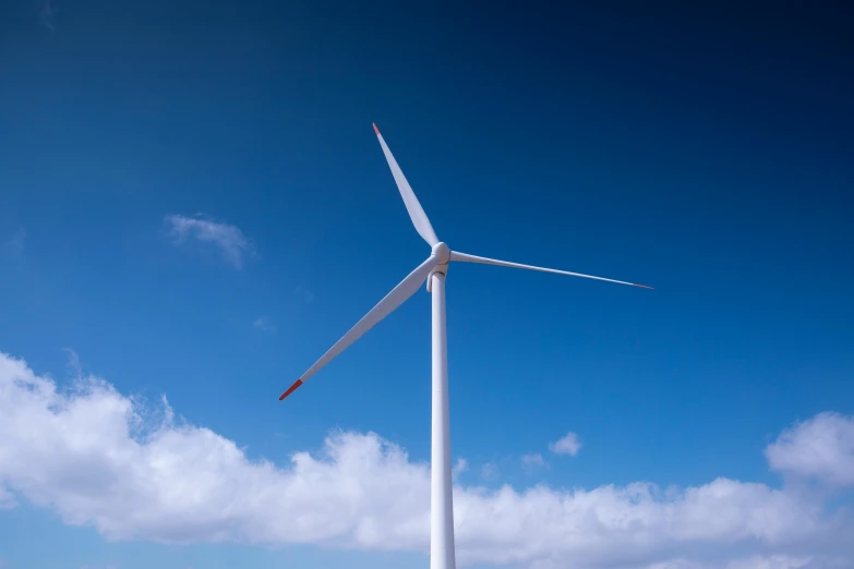 a po of a wind turbine under the blue sky