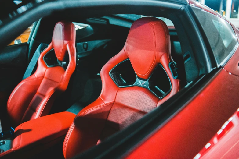 the interior of a red car with leather and red seats