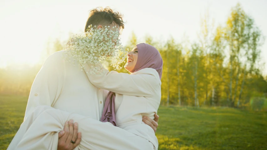 an image of two people holding each other in the park