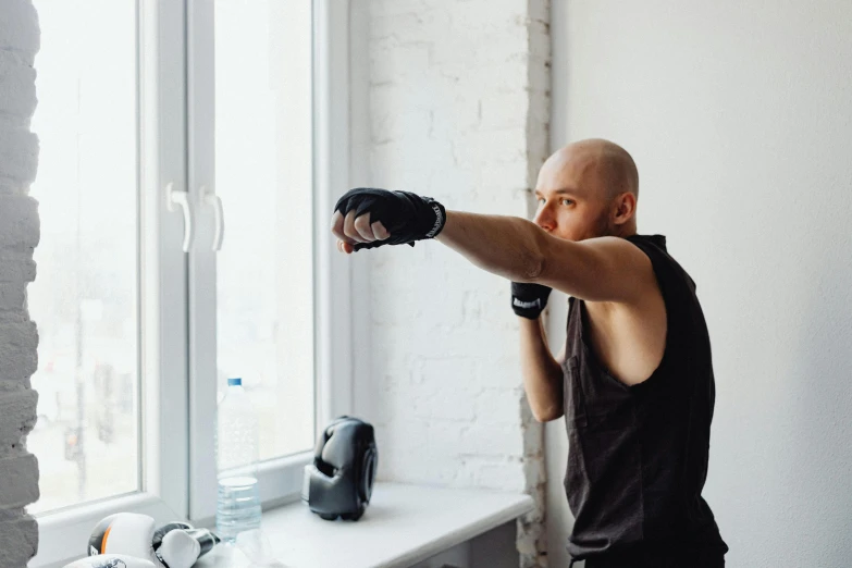 a man using a punching glove on a white counter top