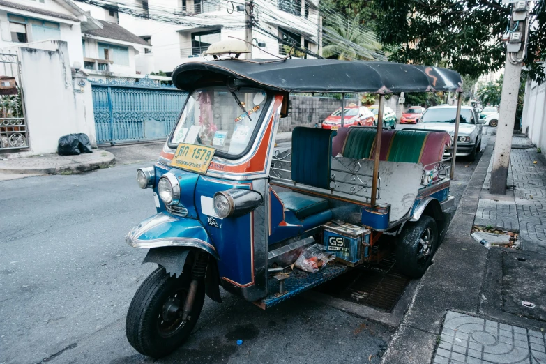 a vehicle parked near a street with people on it