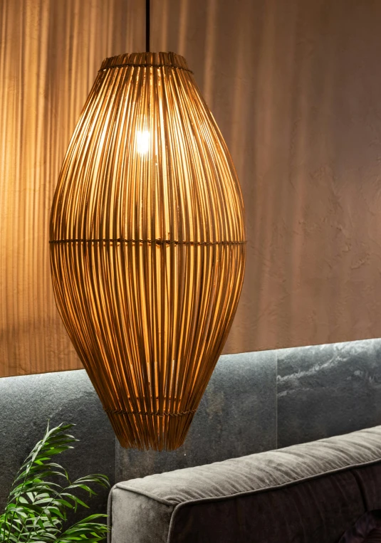 a large rattan hanging lamp with corded lighting