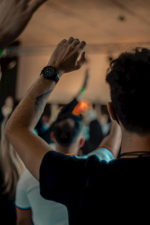 a crowd in an auditorium watches a speaker