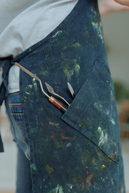 a woman is holding a small tool in her pocket